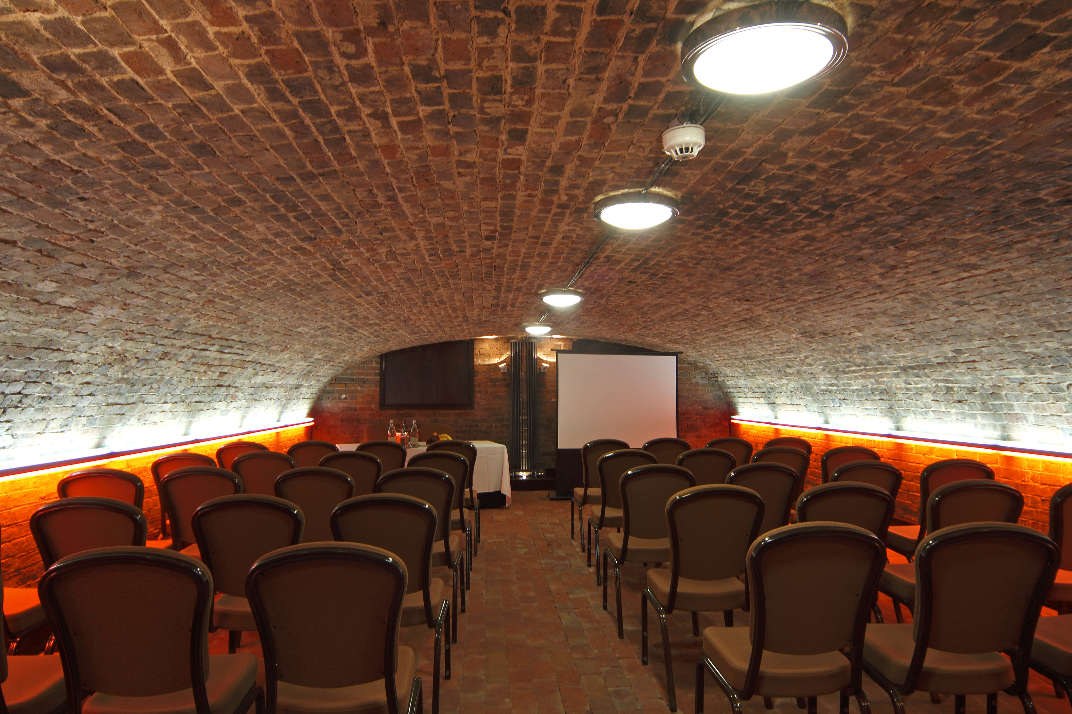 Cellarz meeting space with arched brick ceiling, perfect for corporate events and workshops.