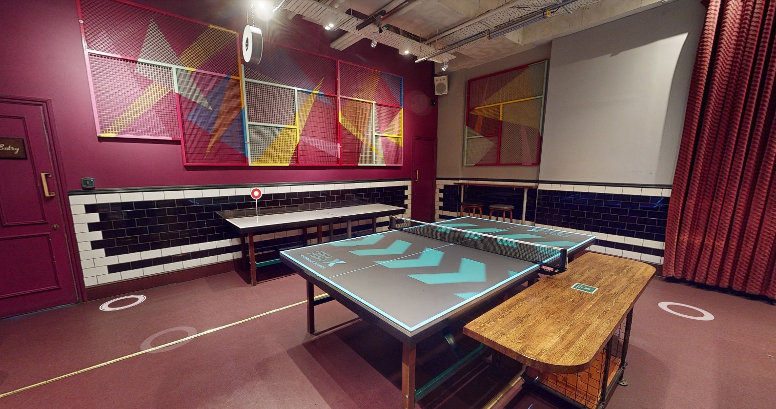 Vibrant meeting space with ping pong table for team-building and networking events.