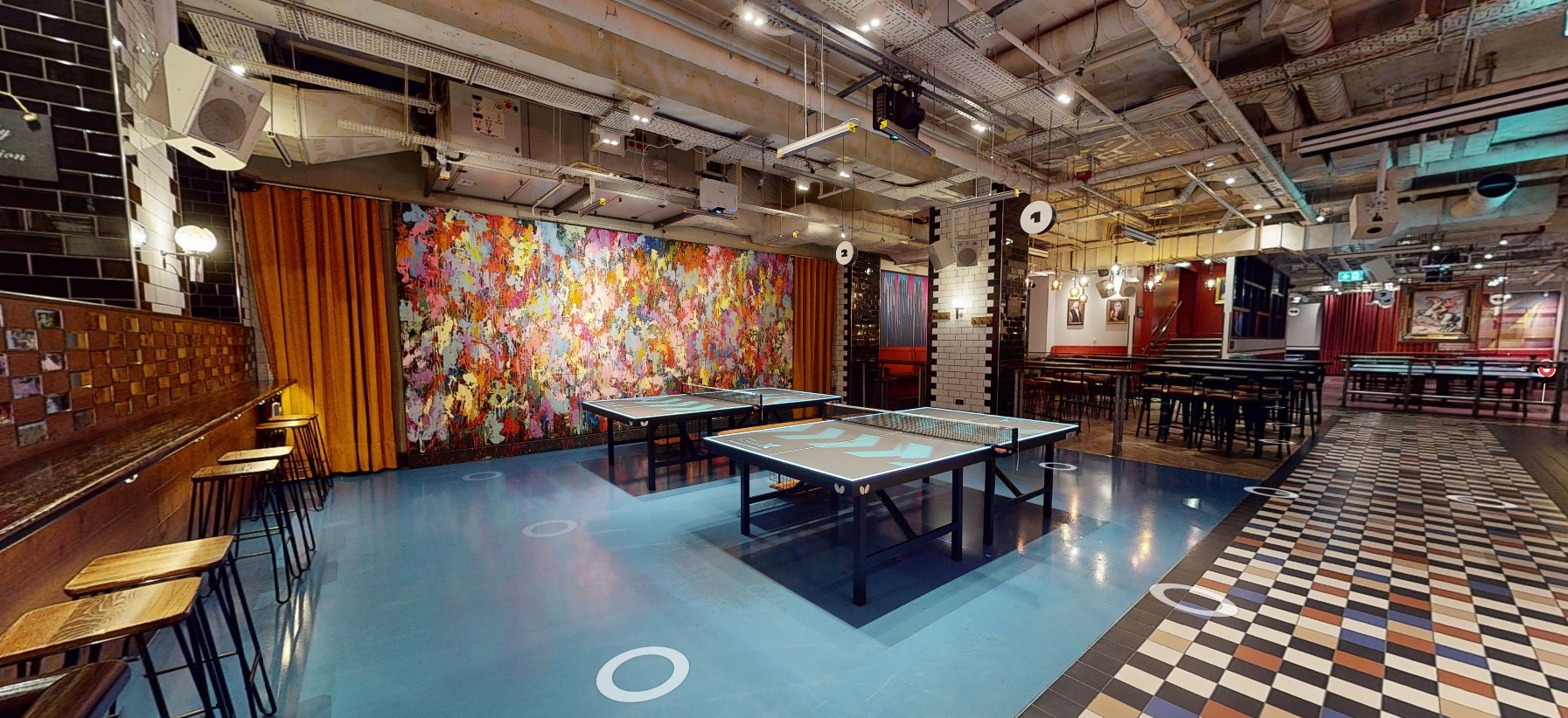 Vibrant event space with ping pong tables for networking and team-building activities.
