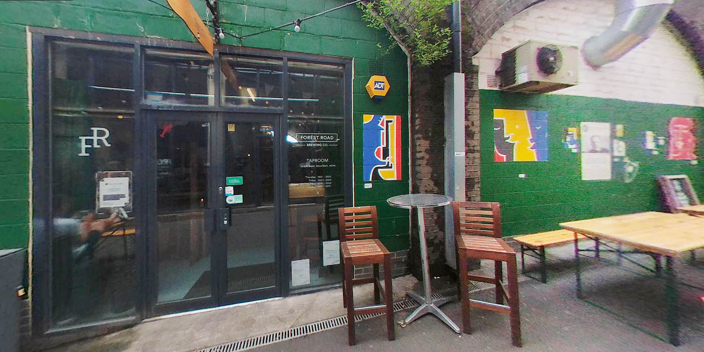 "Vibrant outdoor bar at Forest Road Brewery, perfect for casual meetings and events."