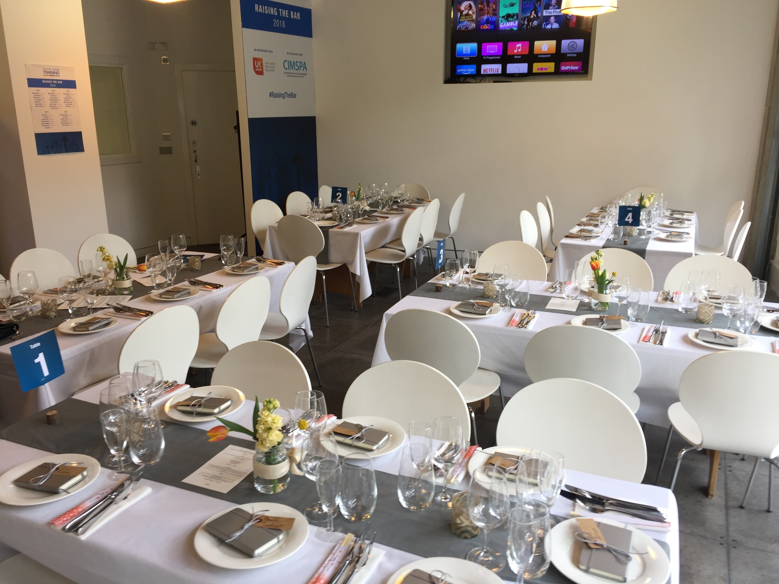 Elegant event space at Jenius Social, set for formal dining and networking.