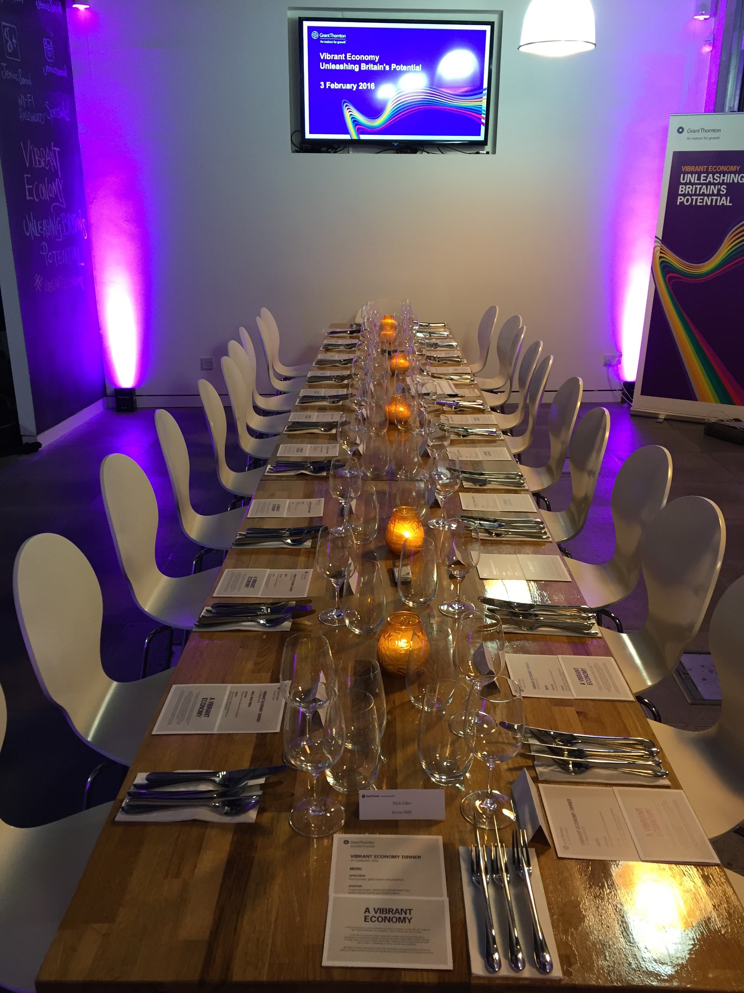 Elegant long dining table setup for formal dinner or networking event at Jenius Social.