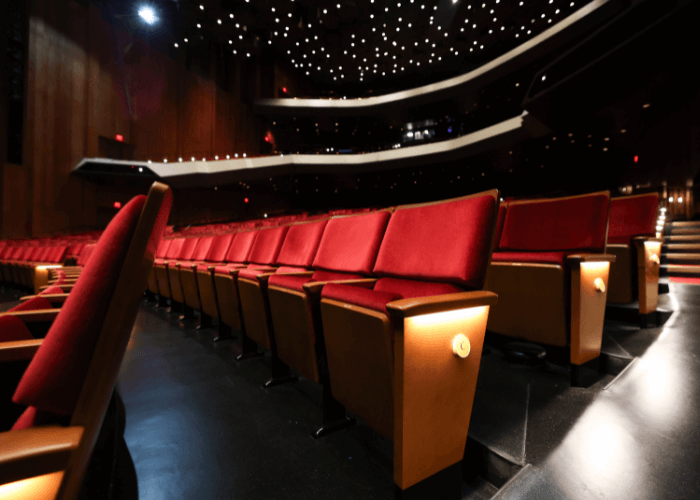 Stage in Jones Hall with plush red seating, ideal for performances and conferences.