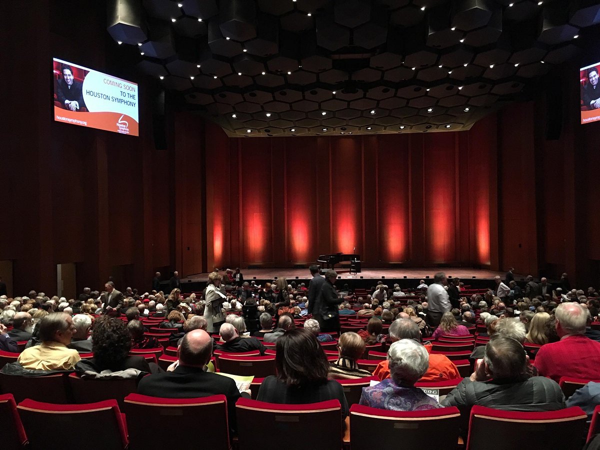 Packed auditorium stage in Jones Hall with elegant lighting for an engaging event.