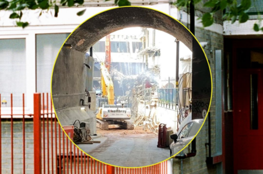 Out-building construction site with urban archway, highlighting event logistics challenges.