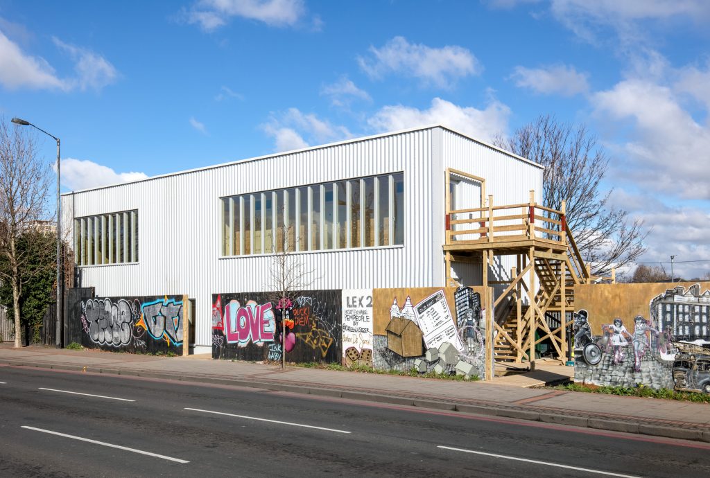 Modern venue with vibrant street art, ideal for creative events and workshops.