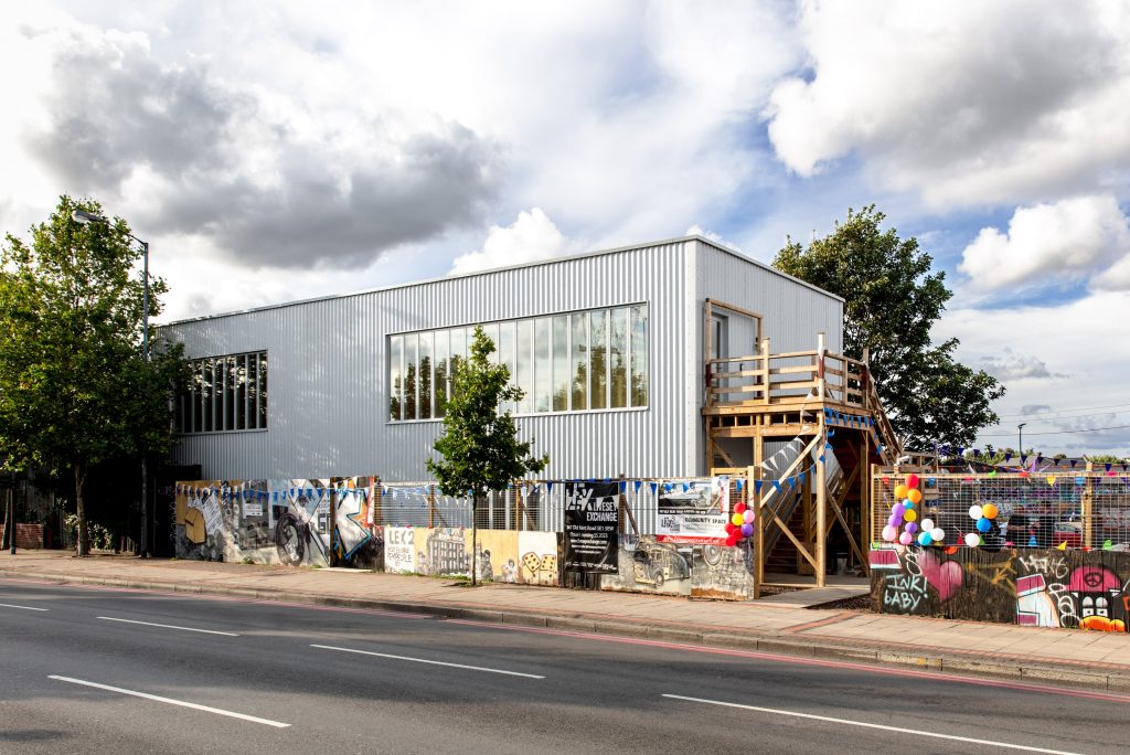 Modern event venue with large windows and colorful artwork, perfect for gatherings.