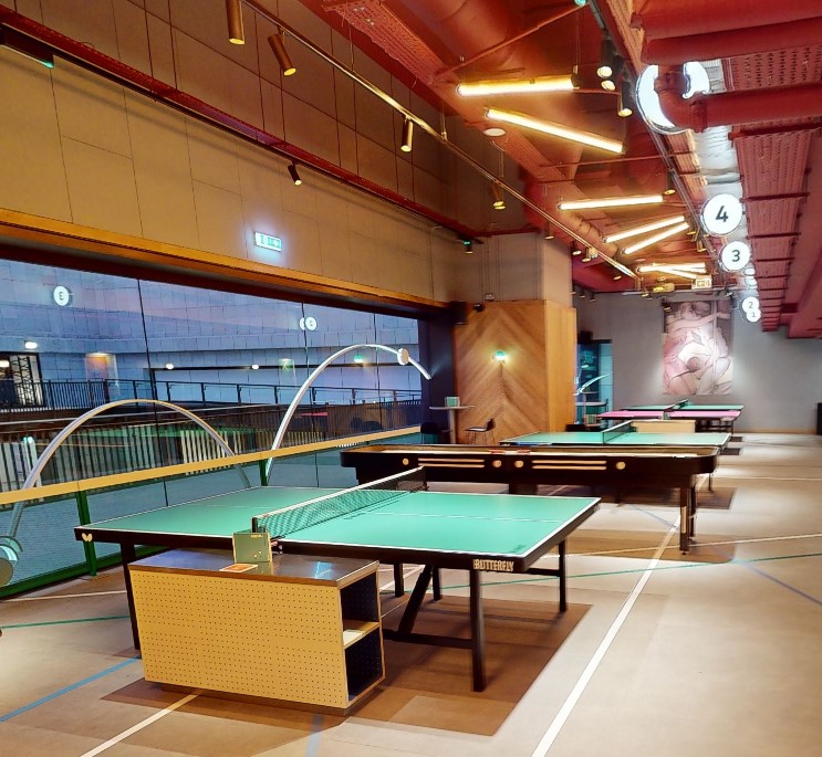 Modern event space with ping pong tables at Bounce Battersea for team-building activities.