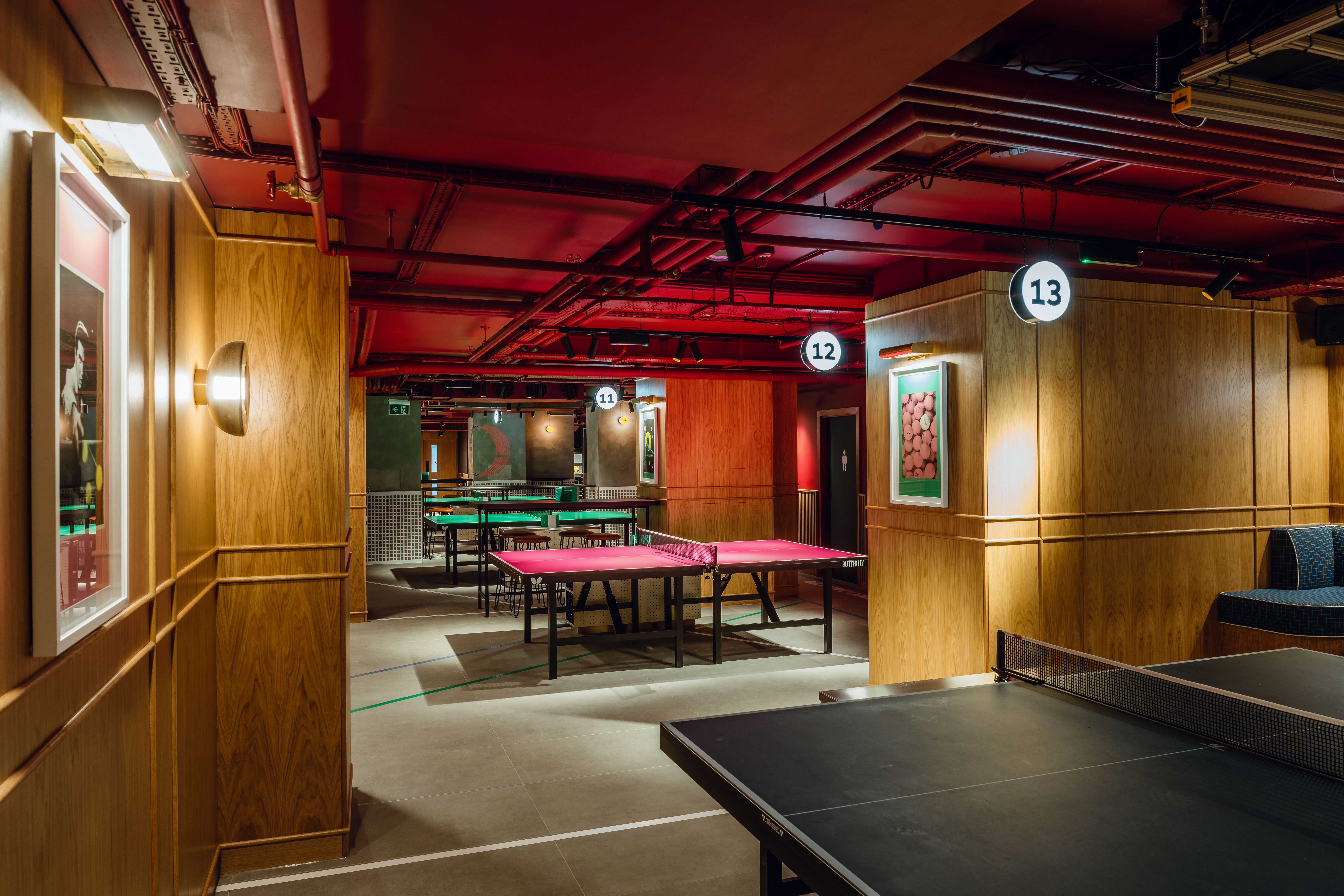 Vibrant event space with ping pong tables at The Hideaway, ideal for team-building activities.