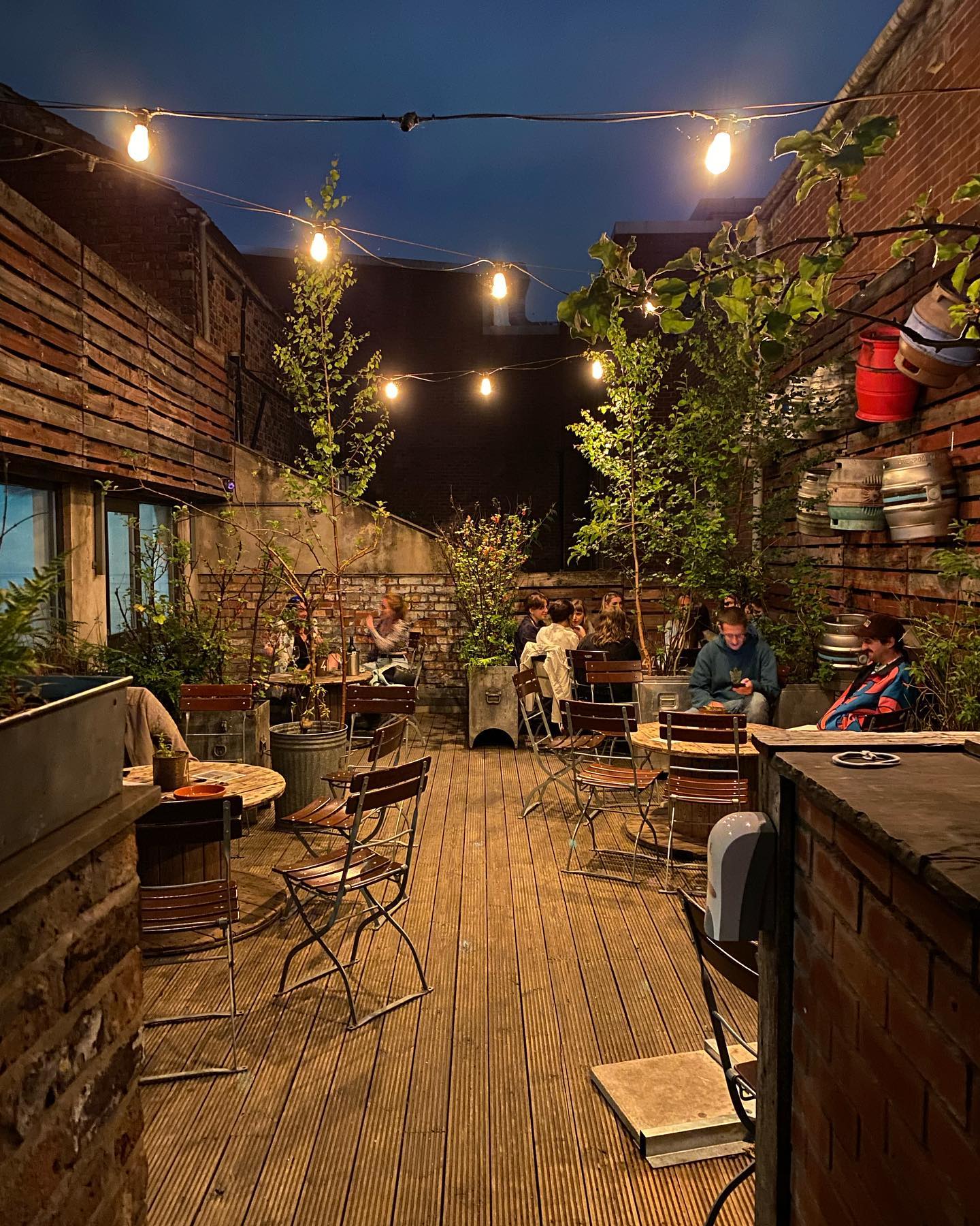 Charming beer garden in Quarter House with rustic decor for relaxed events and networking.