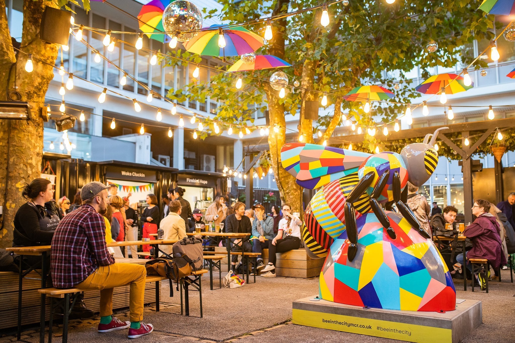 Beer garden at Quarter House with decorative umbrellas, ideal for social gatherings and festivals.