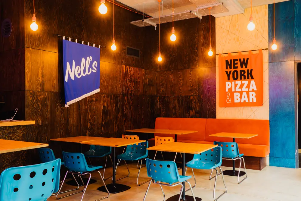 Vibrant bar at Nell's Kampus, featuring eclectic decor for casual meetings and events.
