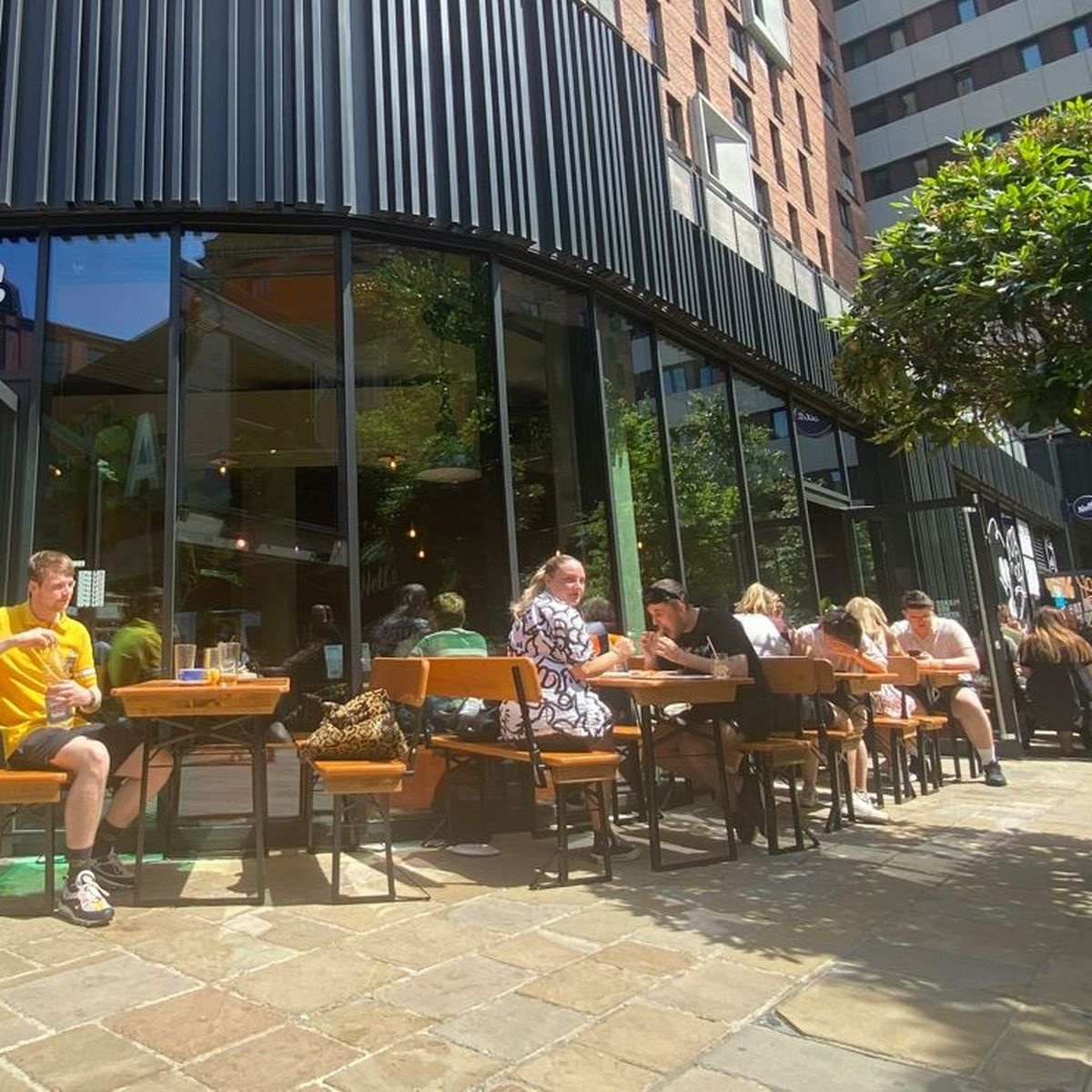 Outdoor dining at Nell's Kampus bar, perfect for casual networking and social gatherings.