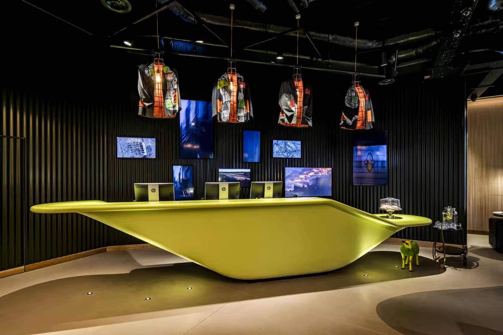 Modern reception area with lime green desk in nhow London for events and meetings.