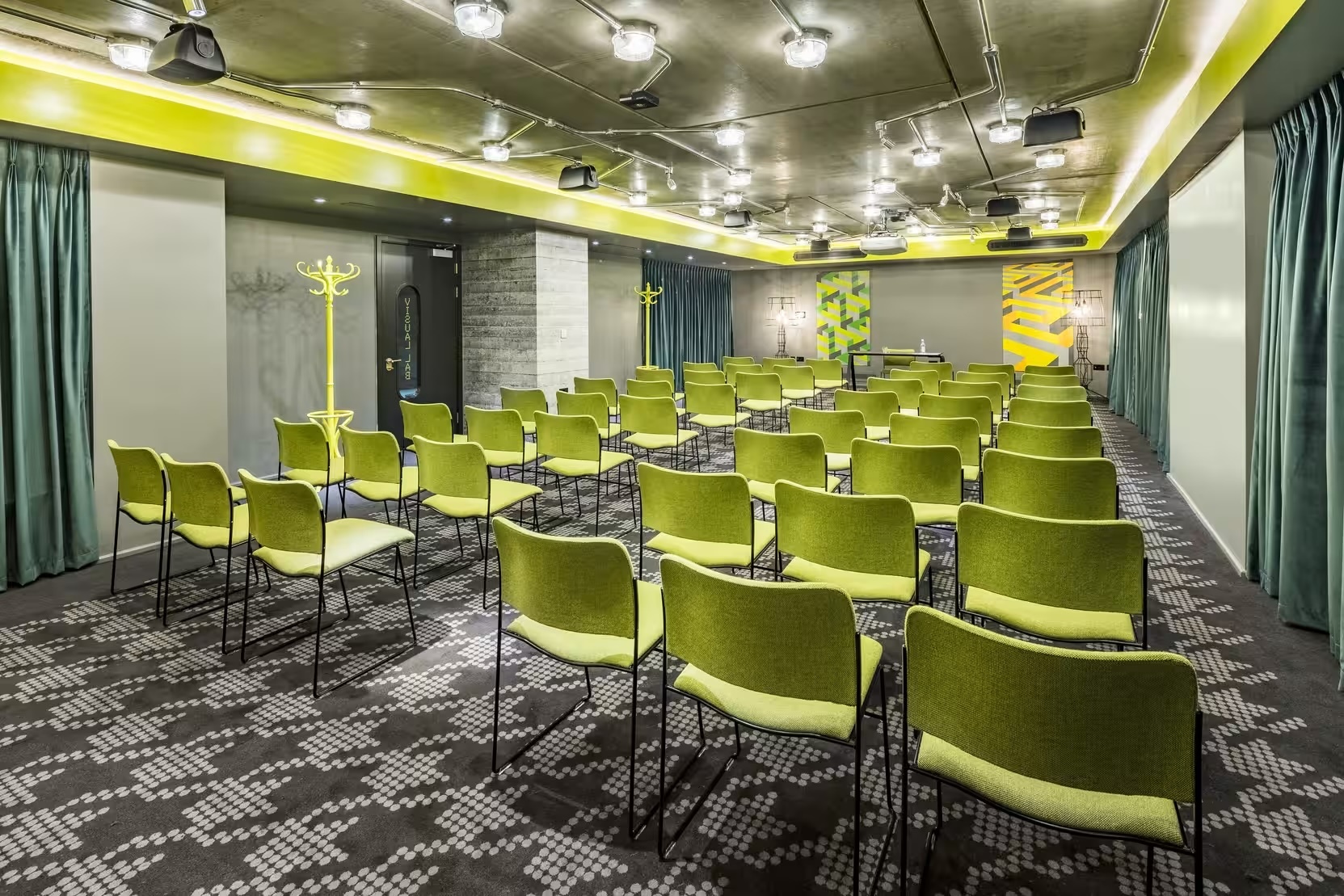 Modern meeting space in nhow London with vibrant green chairs for corporate events.