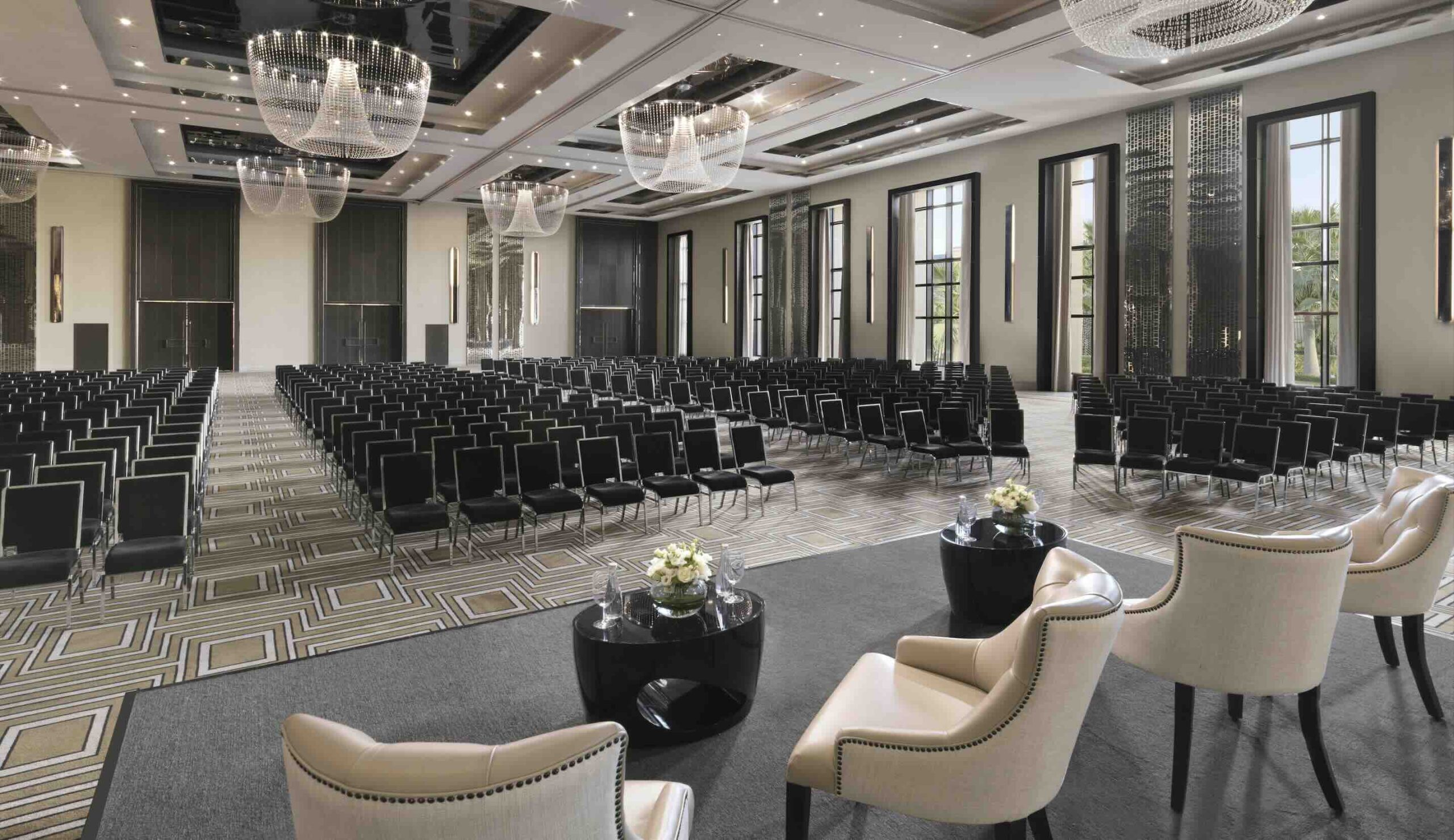 Al Thuraya Ballroom in Fairmont Riyadh with black chairs; ideal for conferences or seminars.