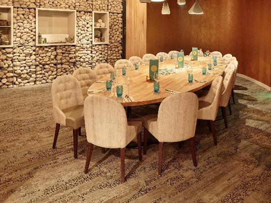 Well-appointed meeting space with wooden table and upholstered chairs for corporate gatherings.