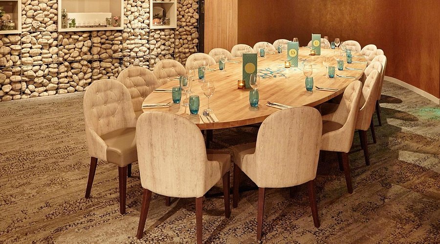 Stylish meeting space with wooden table and plush chairs in Banyan Corn Exchange.