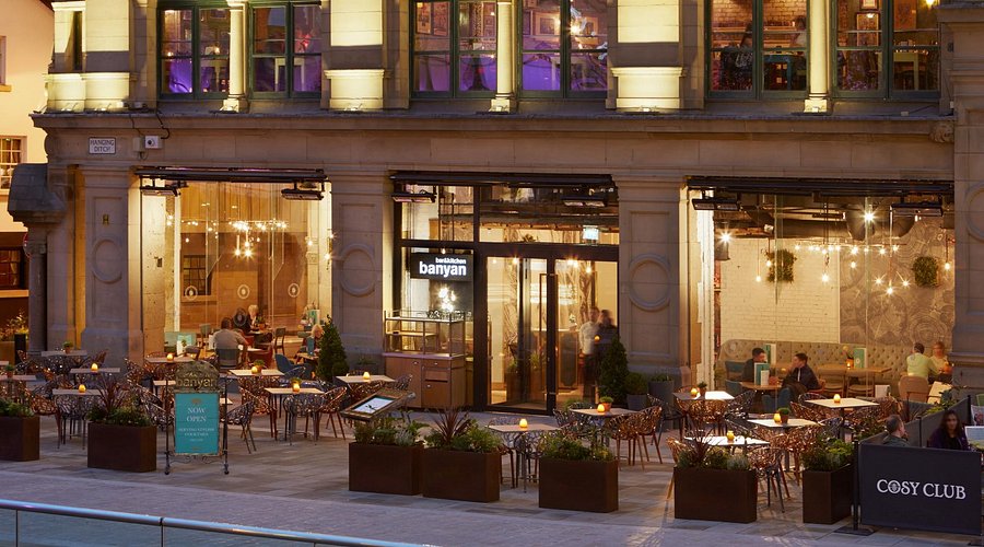 Vibrant restaurant with outdoor seating, perfect for meetings and events in Banyan Corn Exchange.