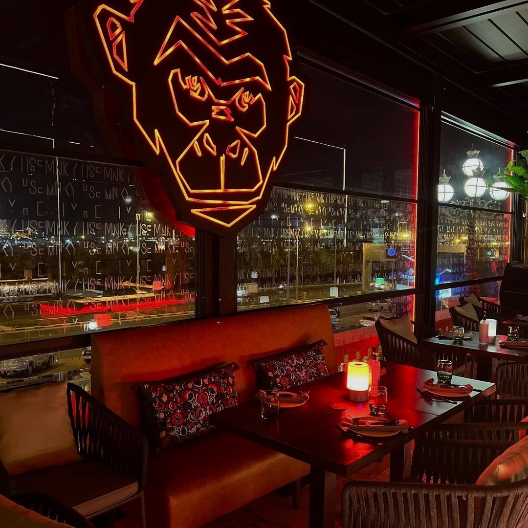 Vibrant Mnky Hse bar with neon gorilla, ideal for corporate events and social gatherings.