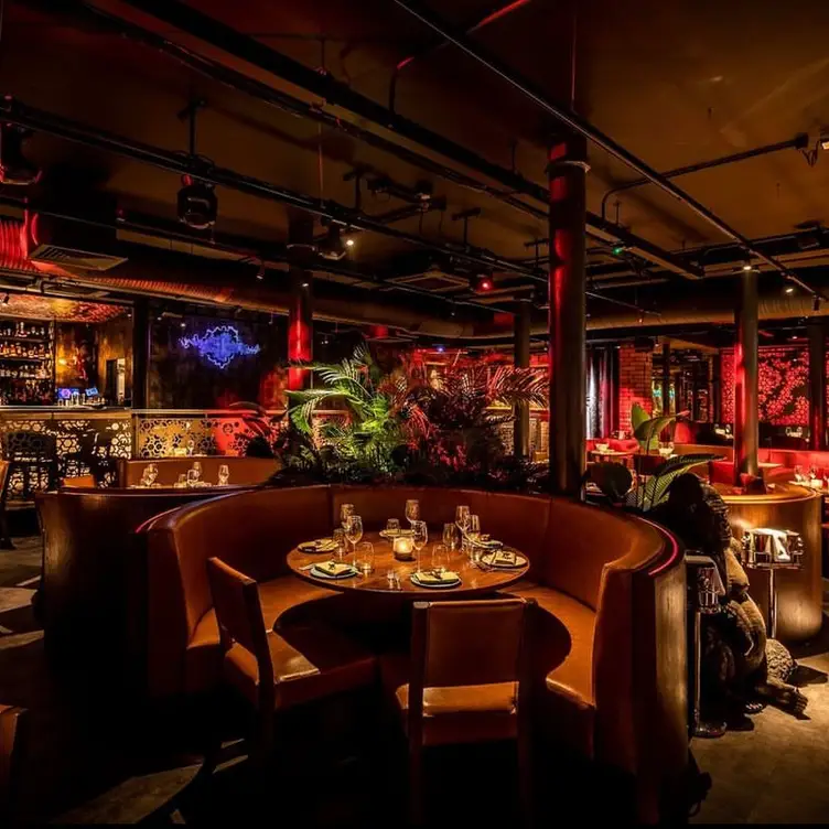 Stylish restaurant bar with warm lighting, perfect for networking events and intimate dinners.