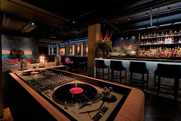 Stylish MNKY Restaurant venue with DJ setup for upscale events and celebrations.