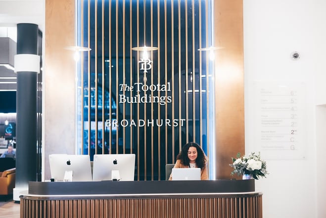 Modern serviced offices reception area with warm wood accents, ideal for professional events.