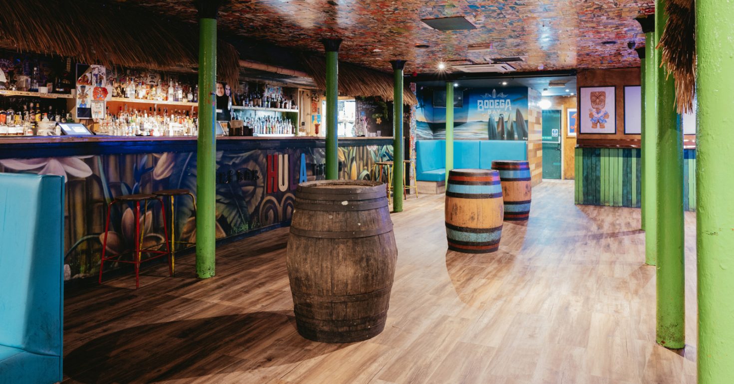 Vibrant Tiki Manchester venue with rustic barrels, ideal for casual gatherings and themed parties.