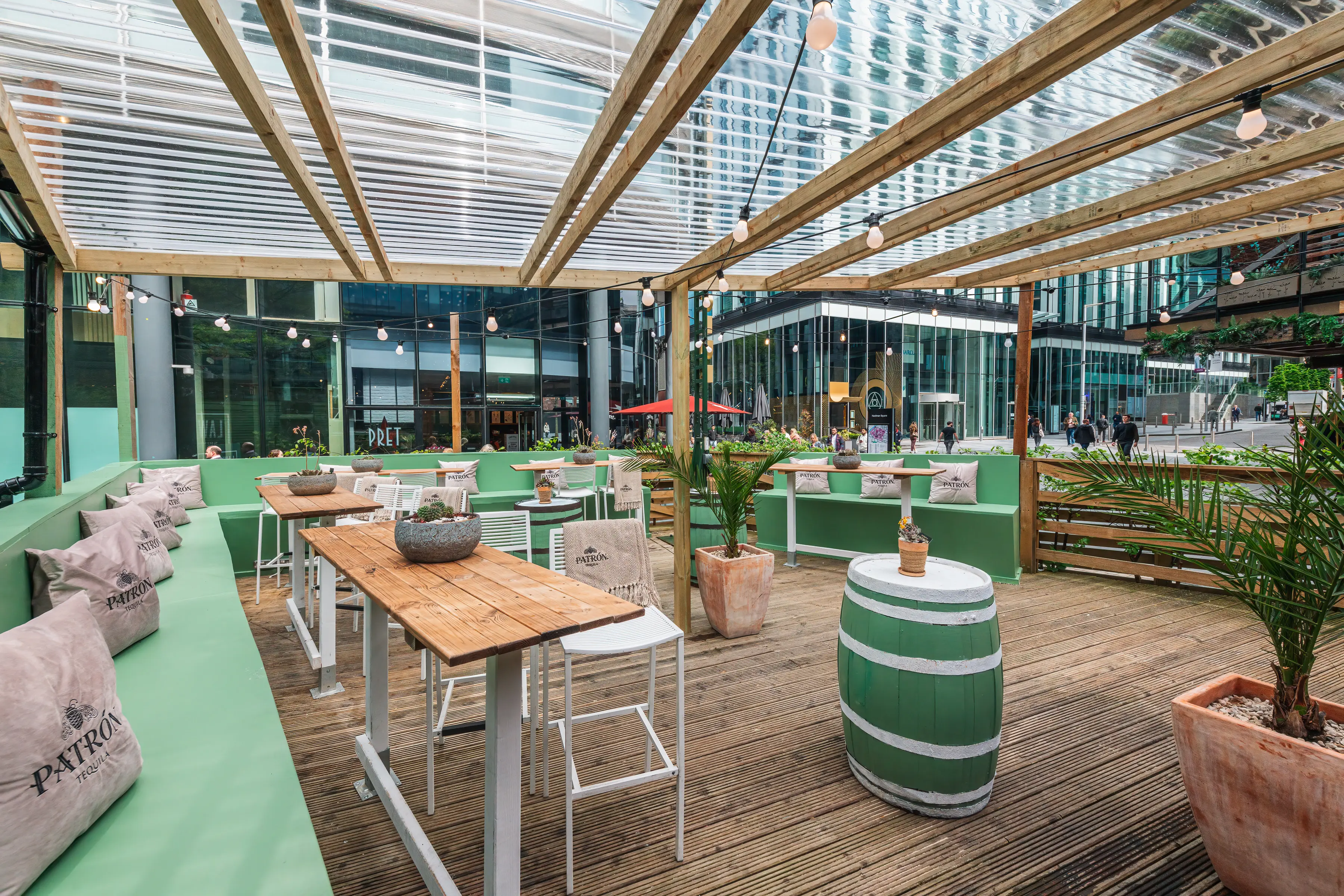 Stylish outdoor event space with wooden tables, ideal for networking and gatherings.