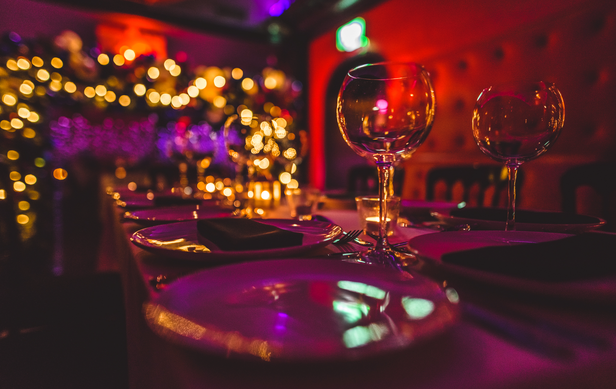 Elegant dining table setup in TOY ROOM for a sophisticated event with warm ambiance.