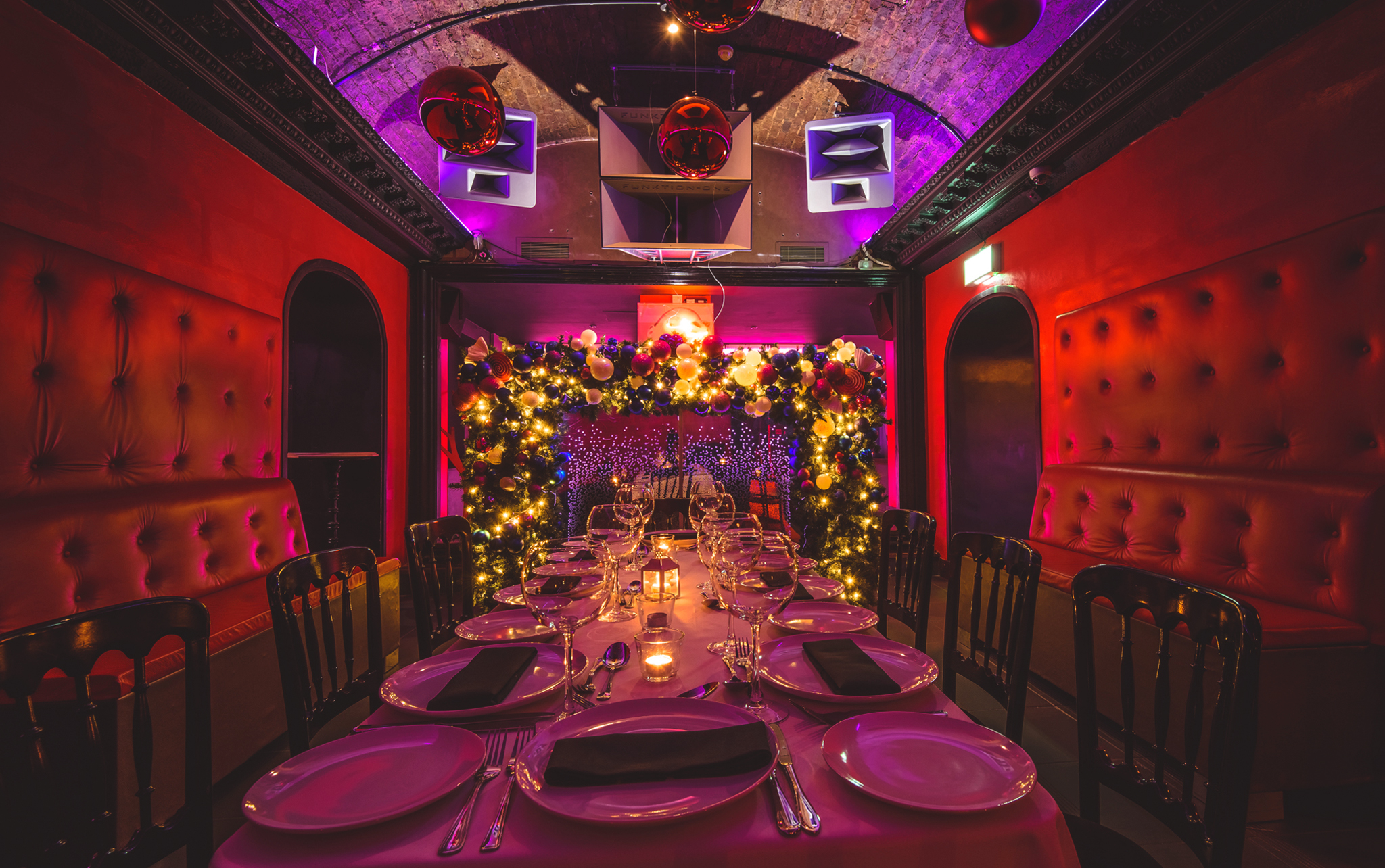 Elegant dining space in Toy Room with vibrant lighting for upscale events and gatherings.