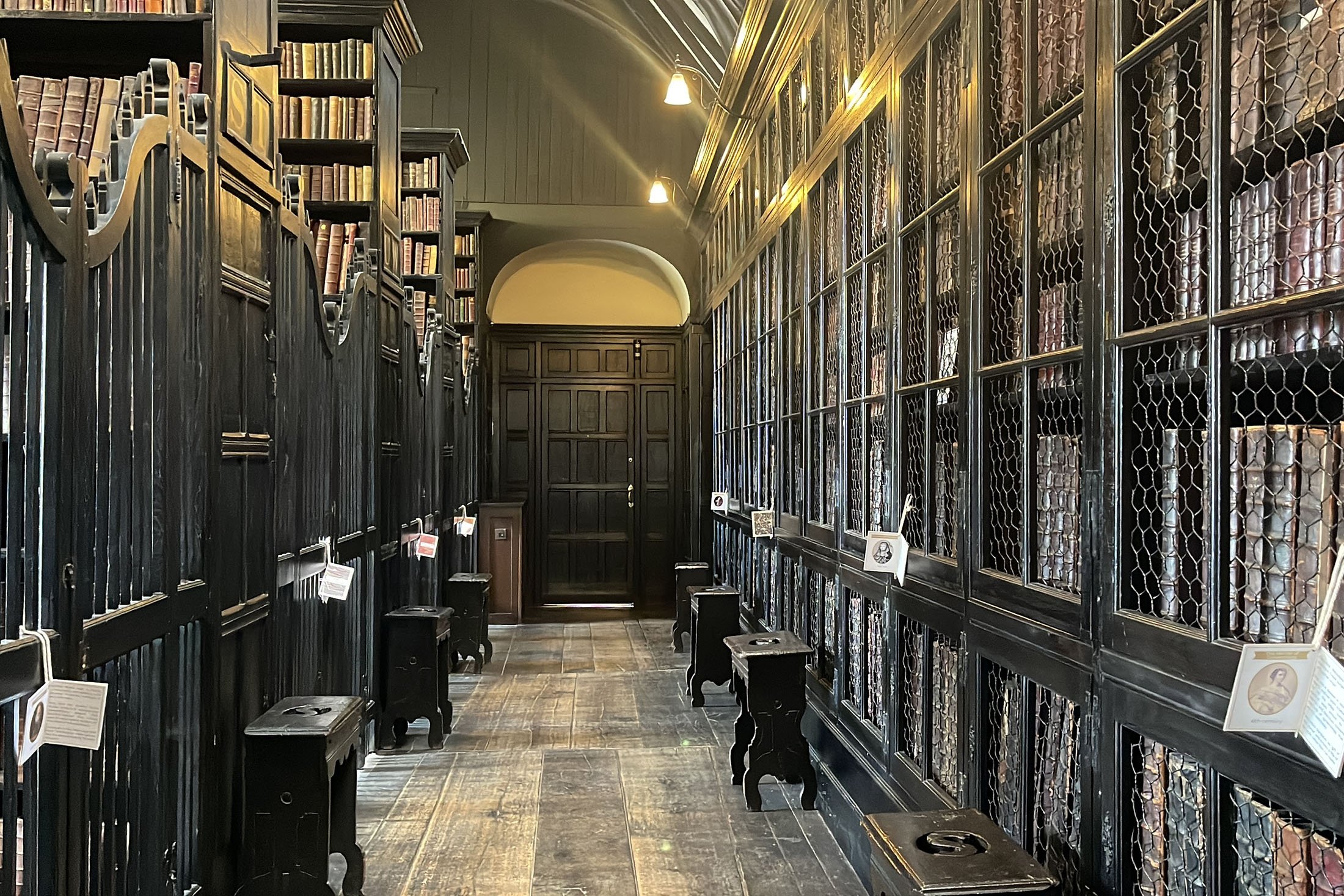 Chetham's Library corridor with dark wooden shelves, perfect for literary events and workshops.