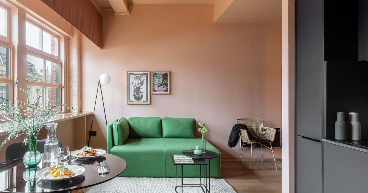 Stylish Whitworth Suite meeting space with vibrant green couch for creative gatherings.