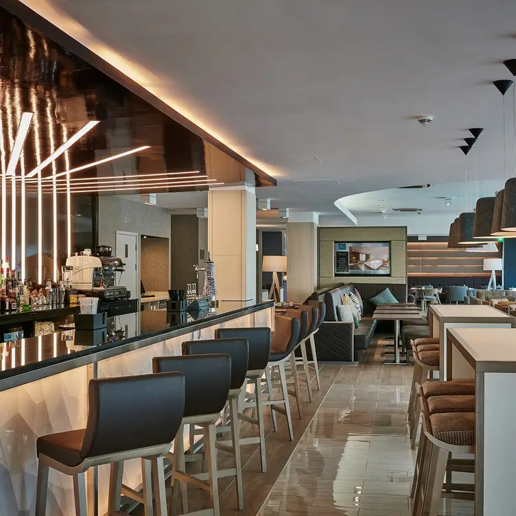 Modern bar area in AC Hotel Manchester, ideal for networking events and casual meetings.