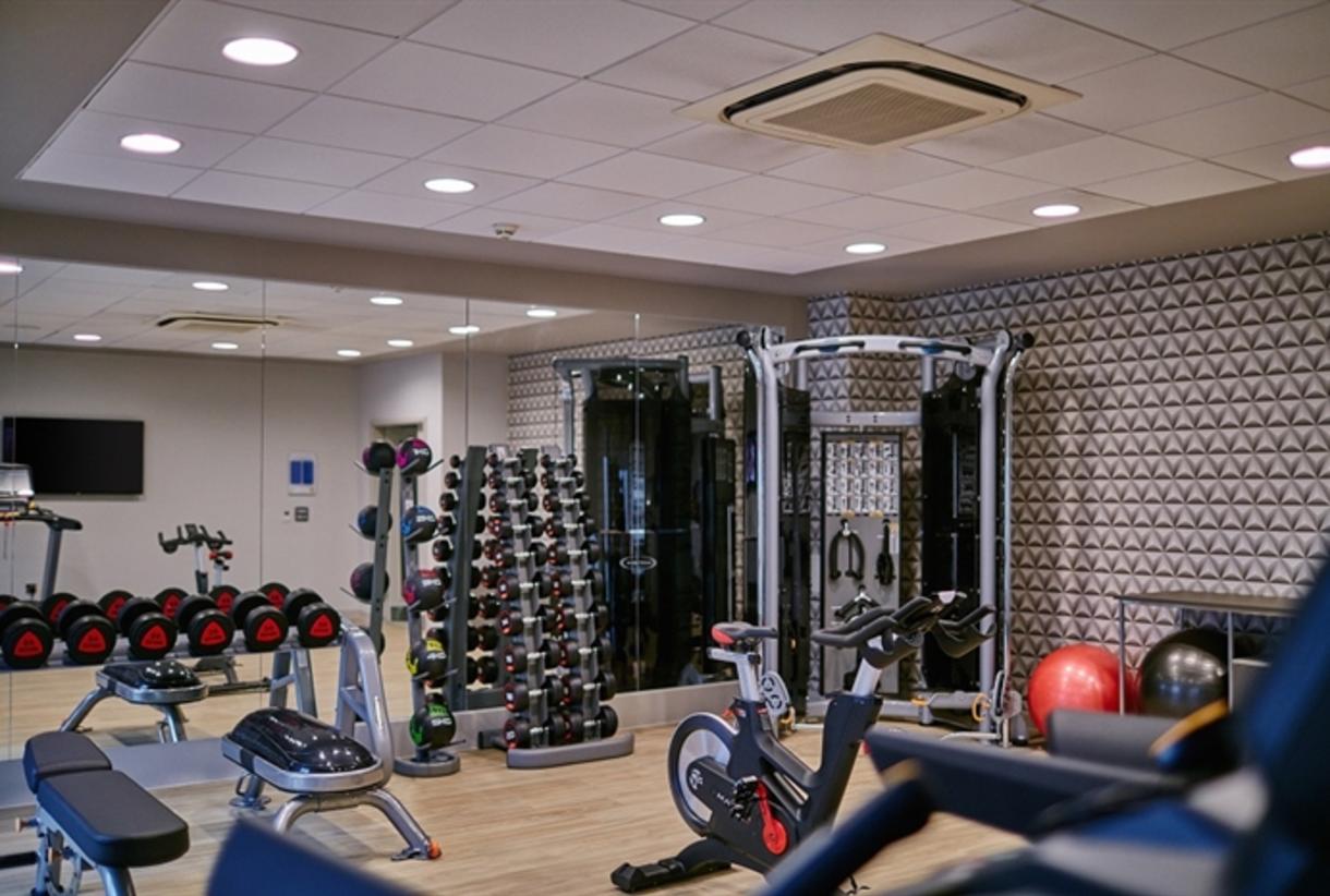 Modern fitness center in AC Hotel Manchester for wellness events and conferences.