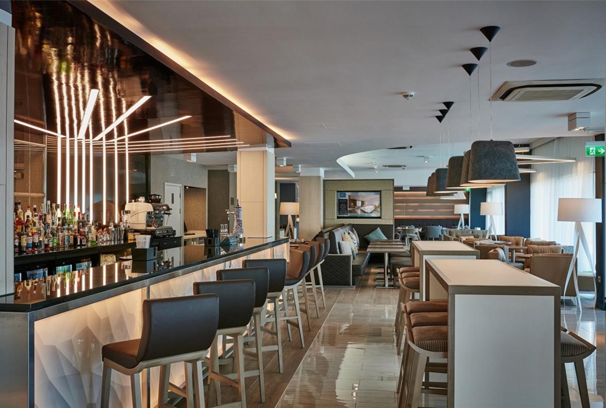 Modern bar area in AC Hotel Manchester for networking events and casual meetings.