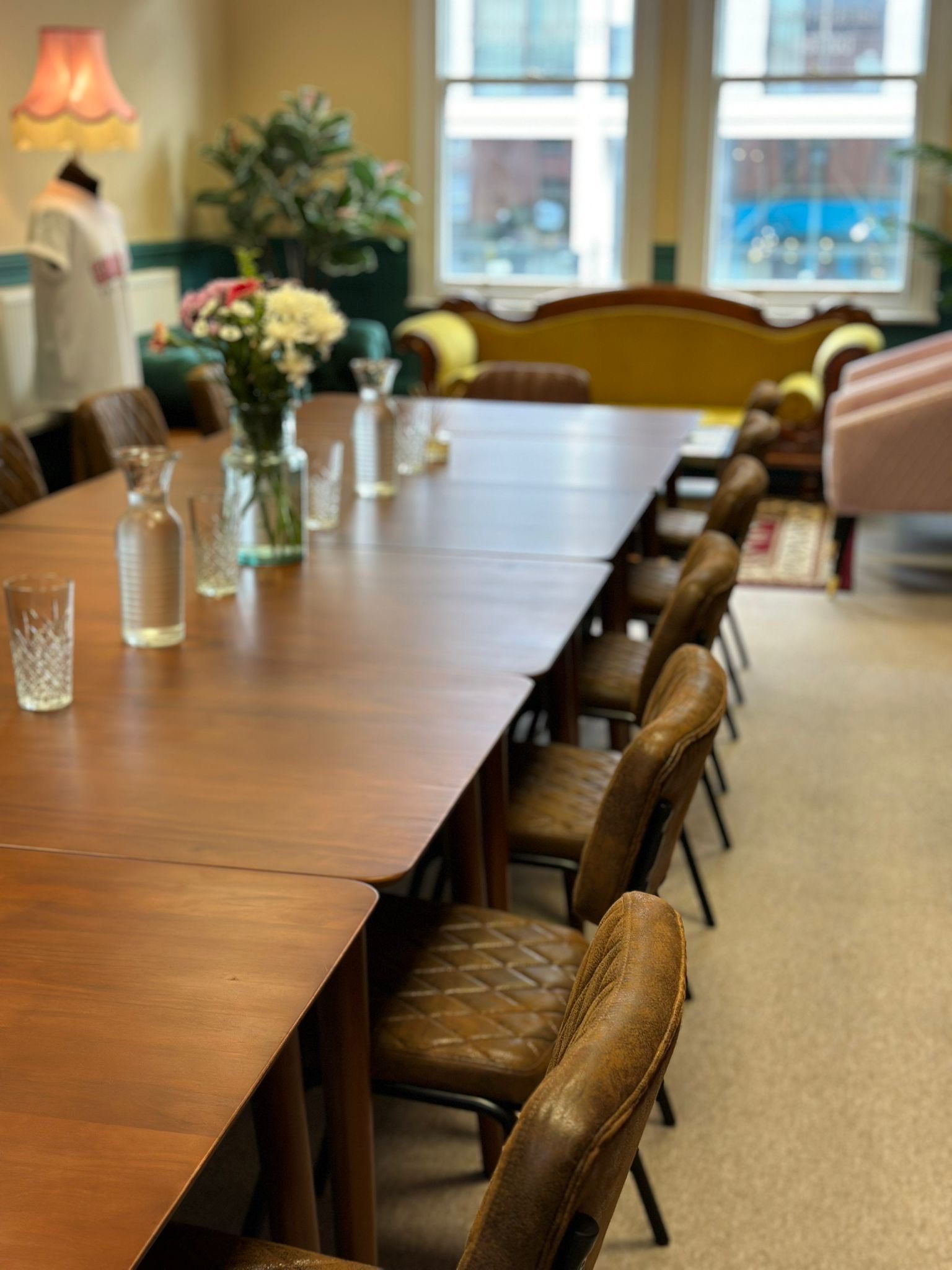 Meeting room at Gran T's Coffee House with wooden table, ideal for collaboration events.