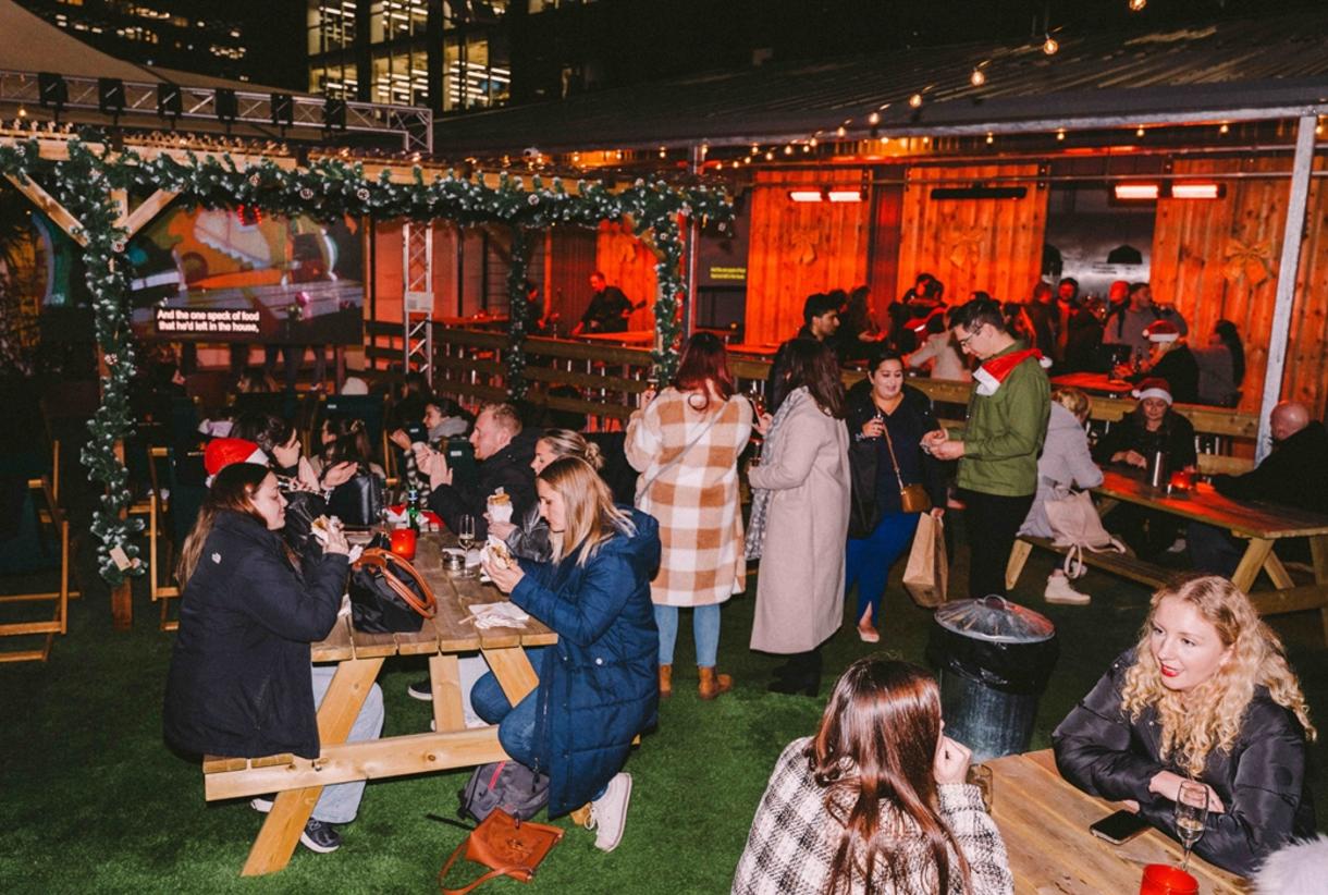 Winter Assembly at Courts Club, vibrant outdoor event with rustic decor and social networking.