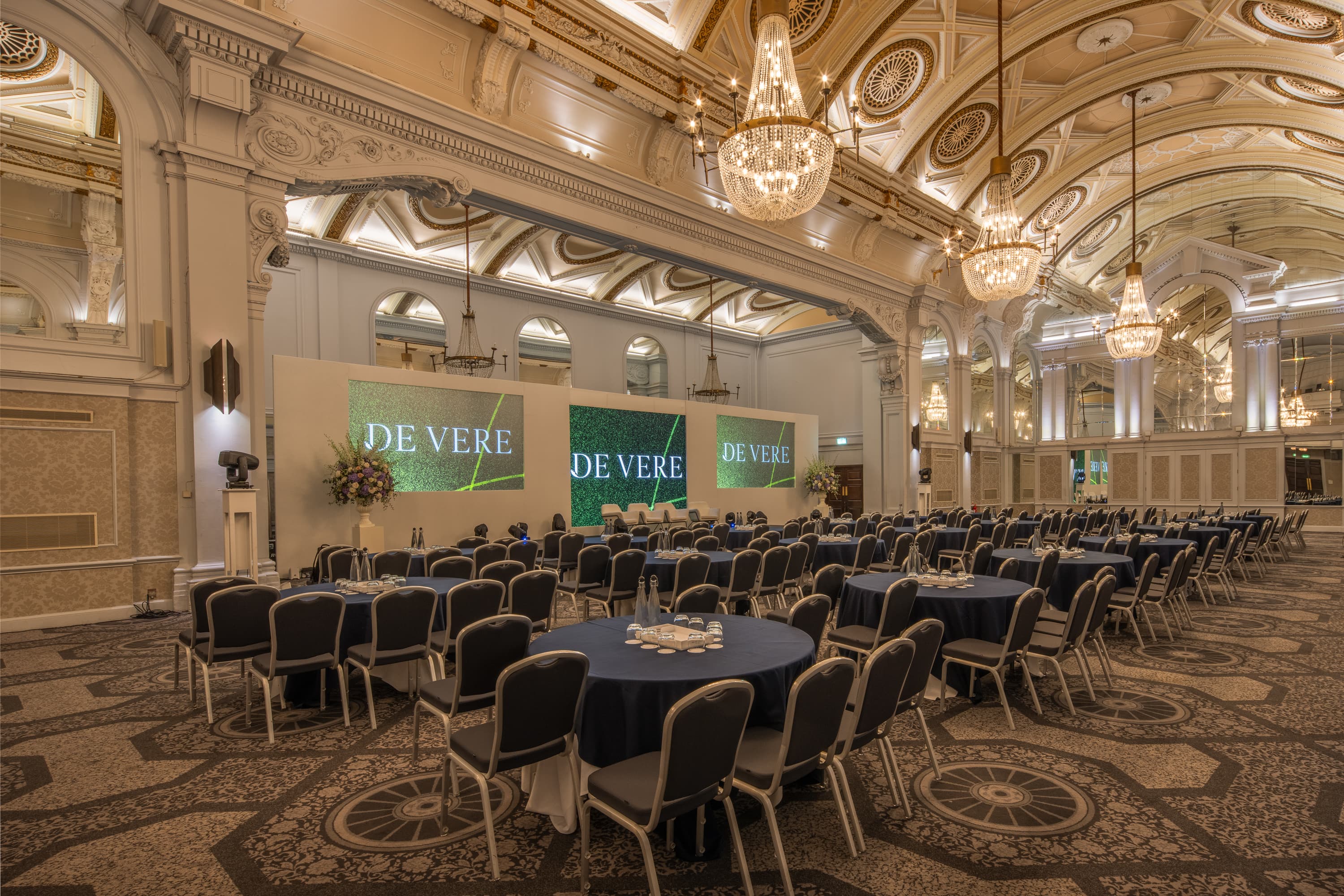Grand Connaught Rooms gala ballroom with branded stage for corporate conferences and events.