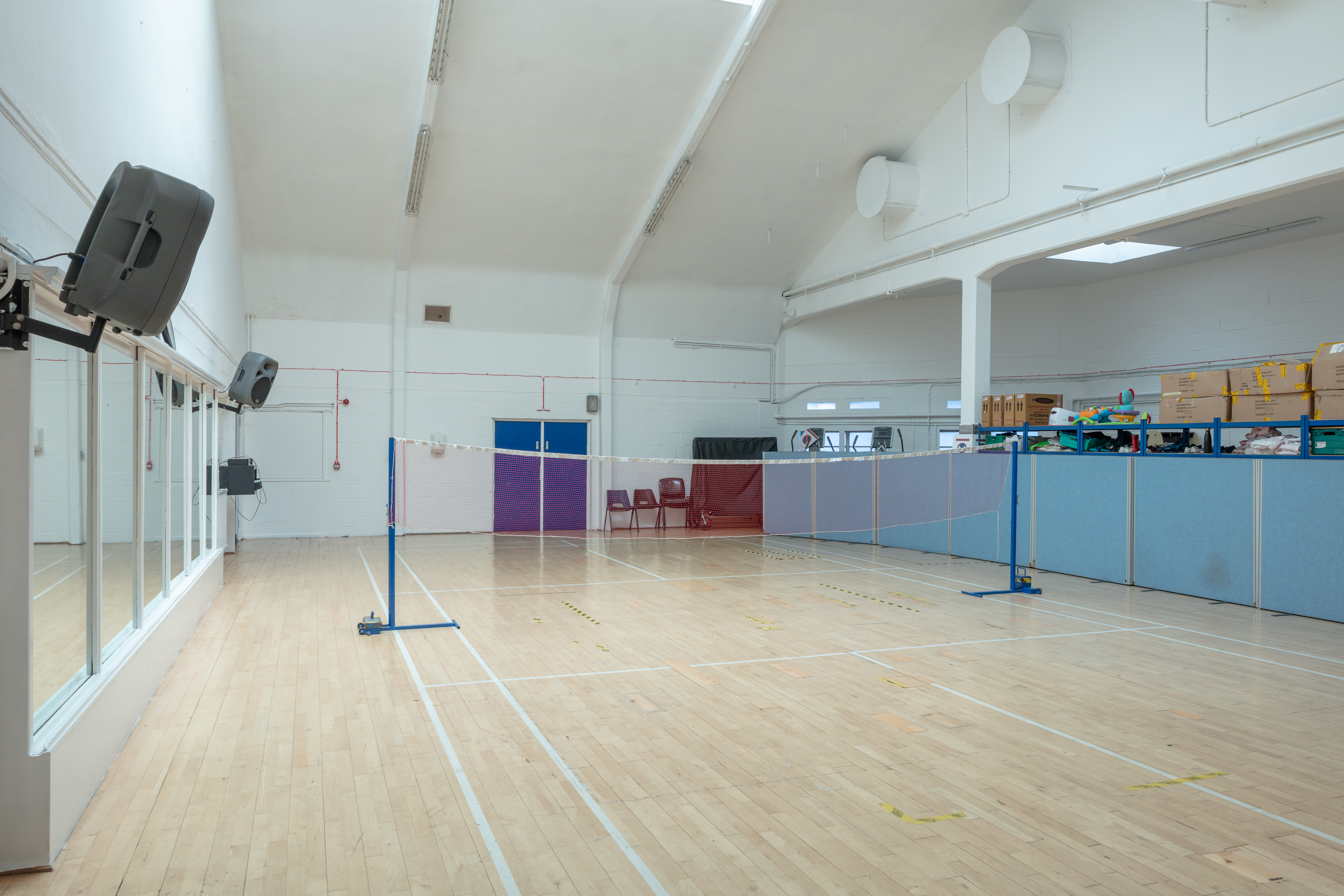 Versatile indoor event space in Colombo with natural light and badminton nets.