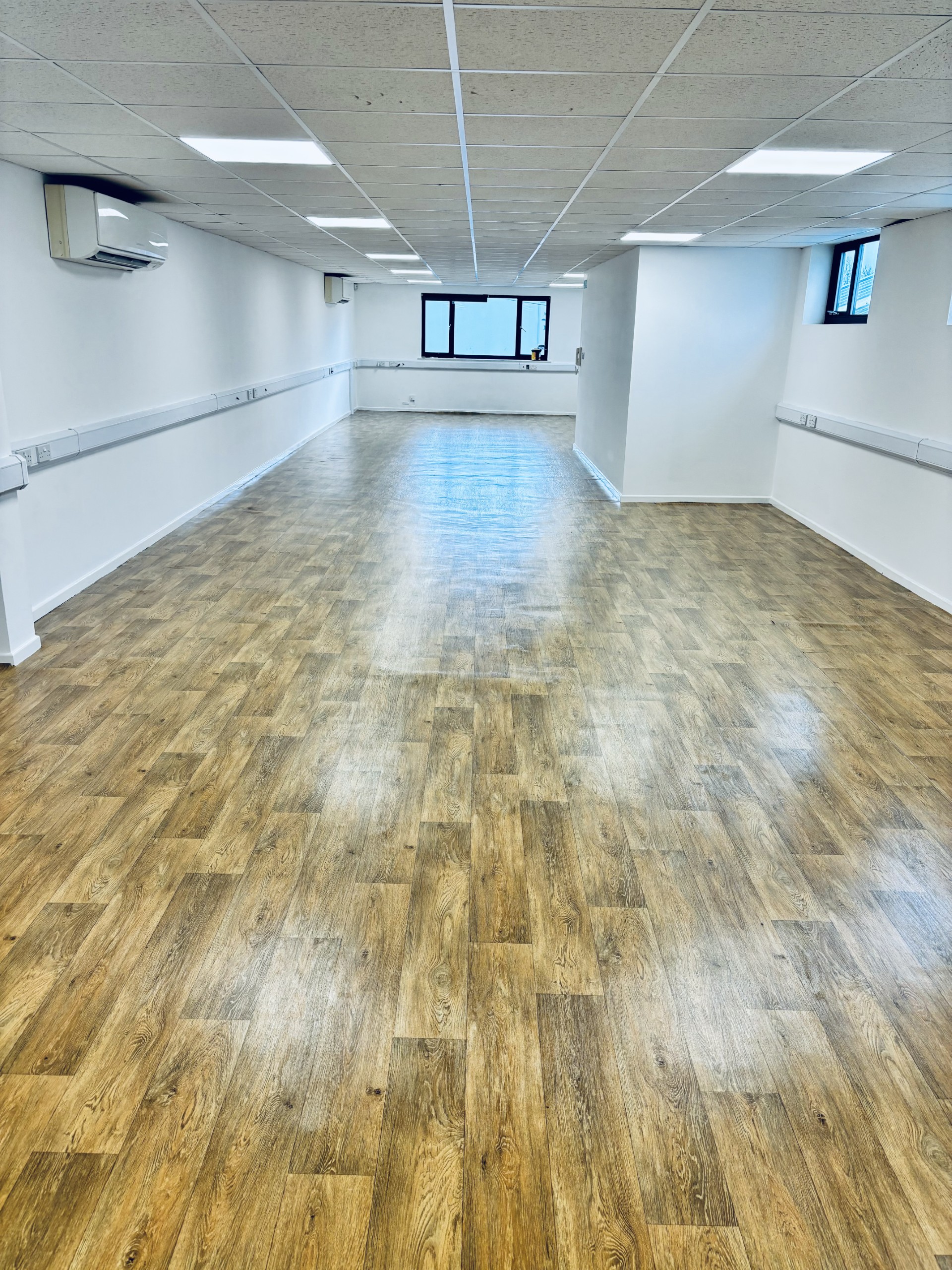Loft Studio meeting room in Bristol, featuring polished wooden floors for events and workshops.
