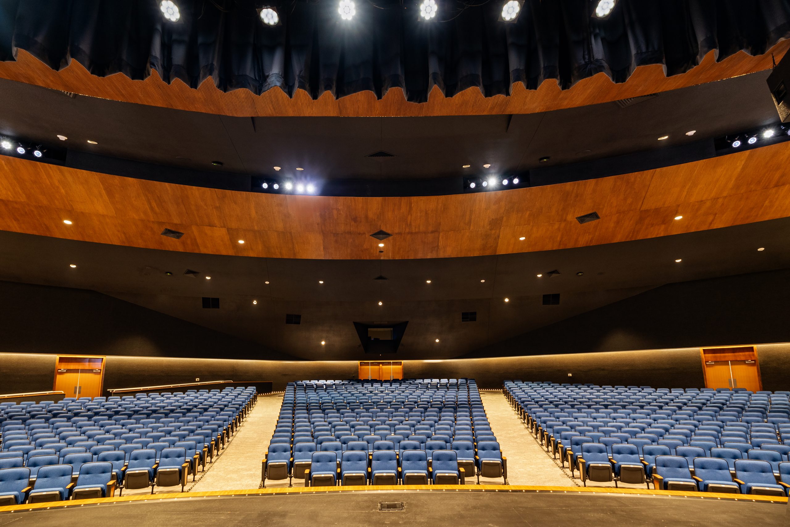 "Spacious auditorium with tiered seating, perfect for events and presentations"