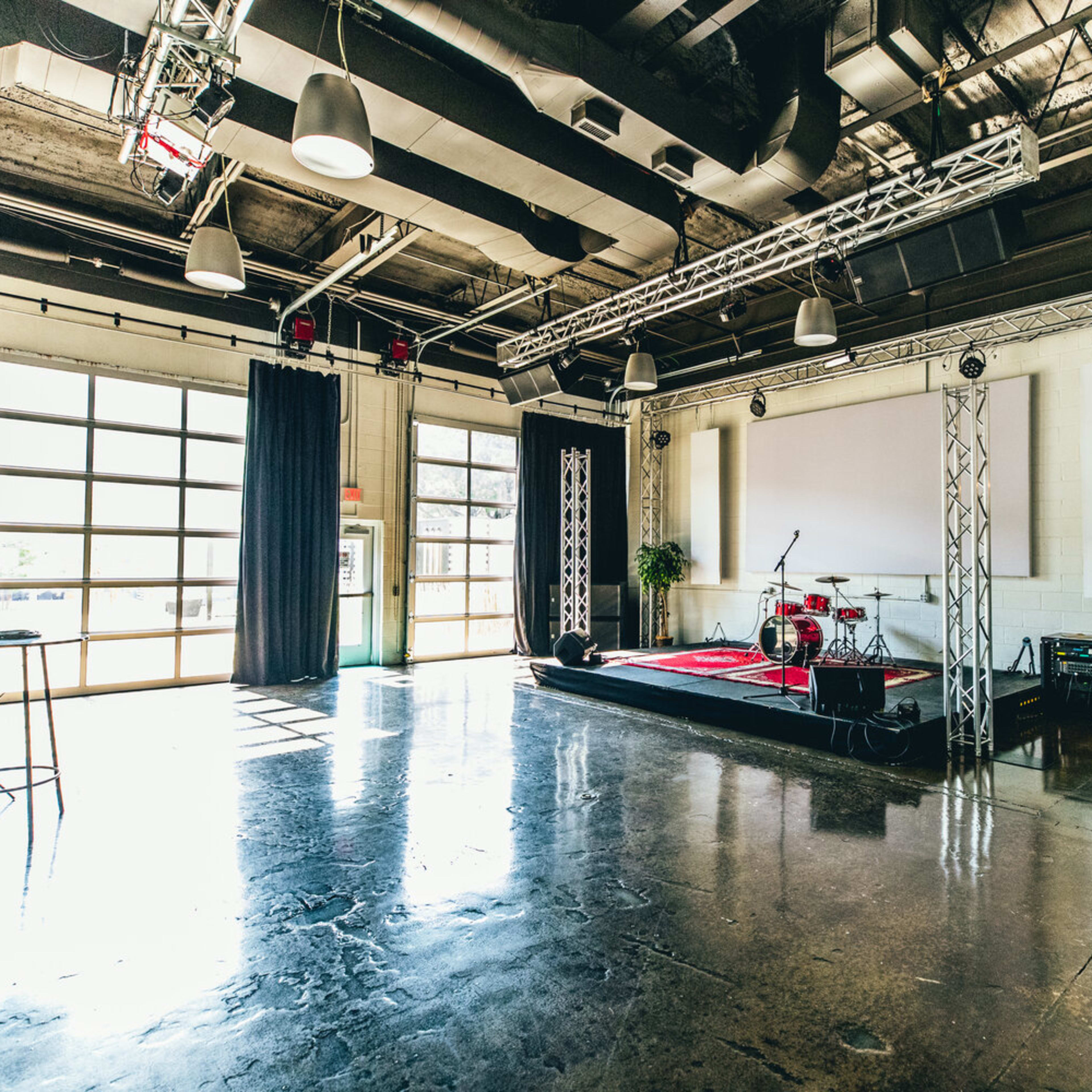 Event Hall at Spring Hill Event Center with elevated stage, ideal for corporate events.