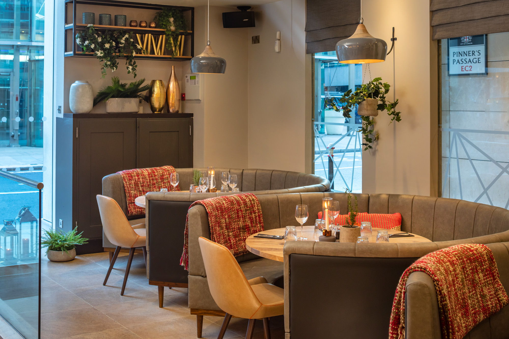 Stylish dining area with cozy booths for intimate meetings and events at The Otherist.
