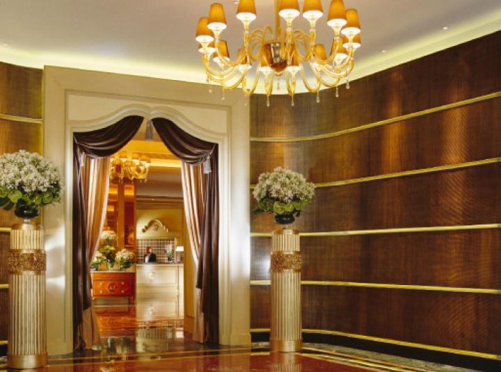 Elegant hotel entrance with chandelier, ideal for upscale events and meetings.