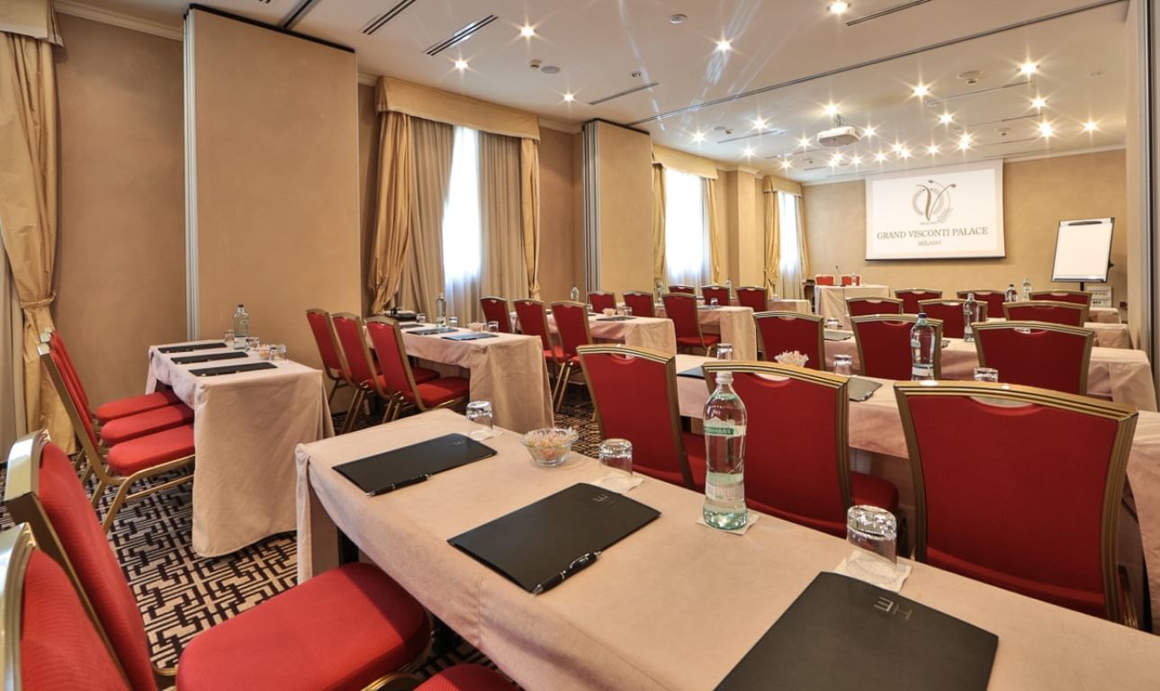 Function room in Palazzo Visconti with elegant tables, ideal for corporate meetings and workshops.
