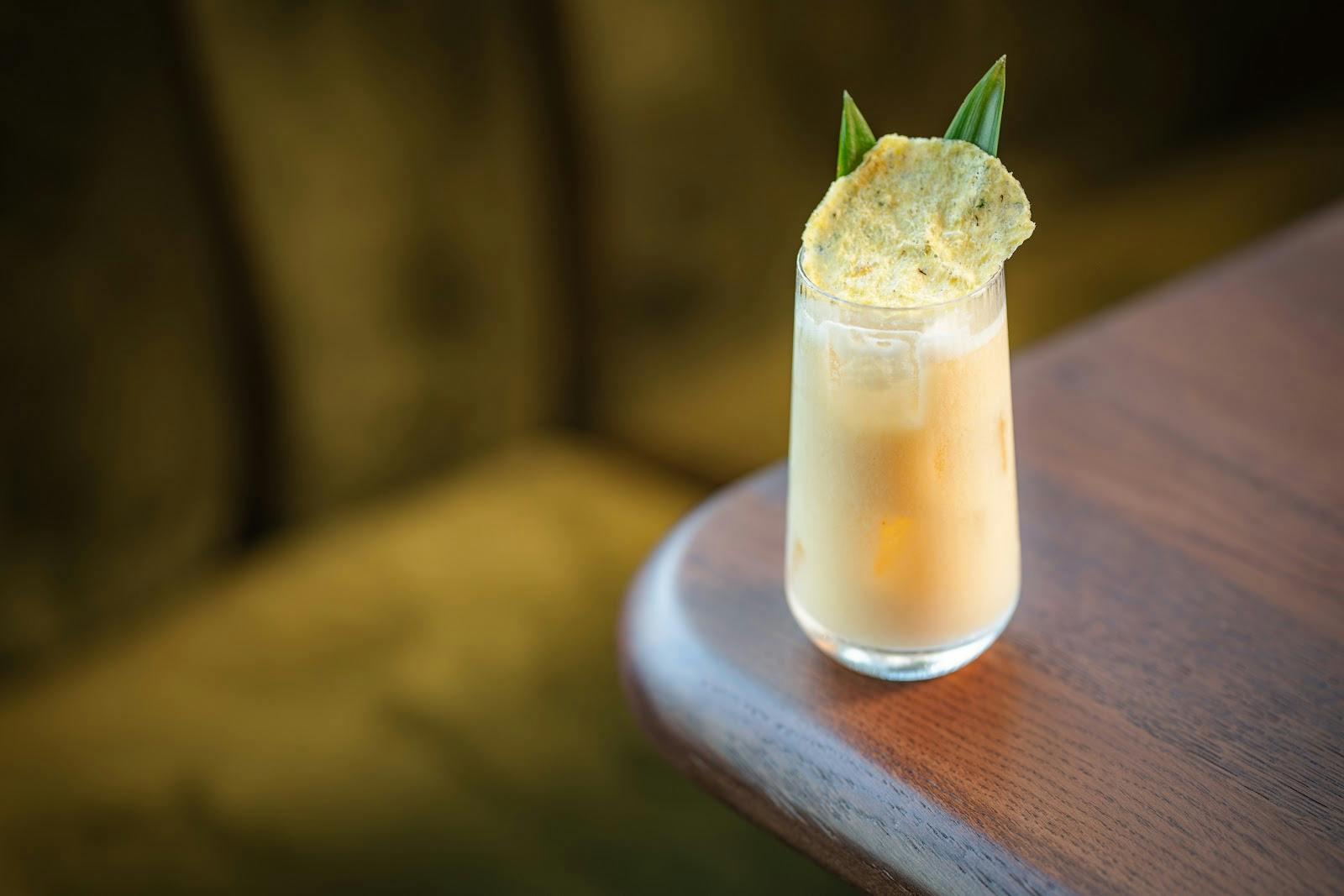 "Signature cocktail with vibrant garnishes at HERA Restaurant for networking events."