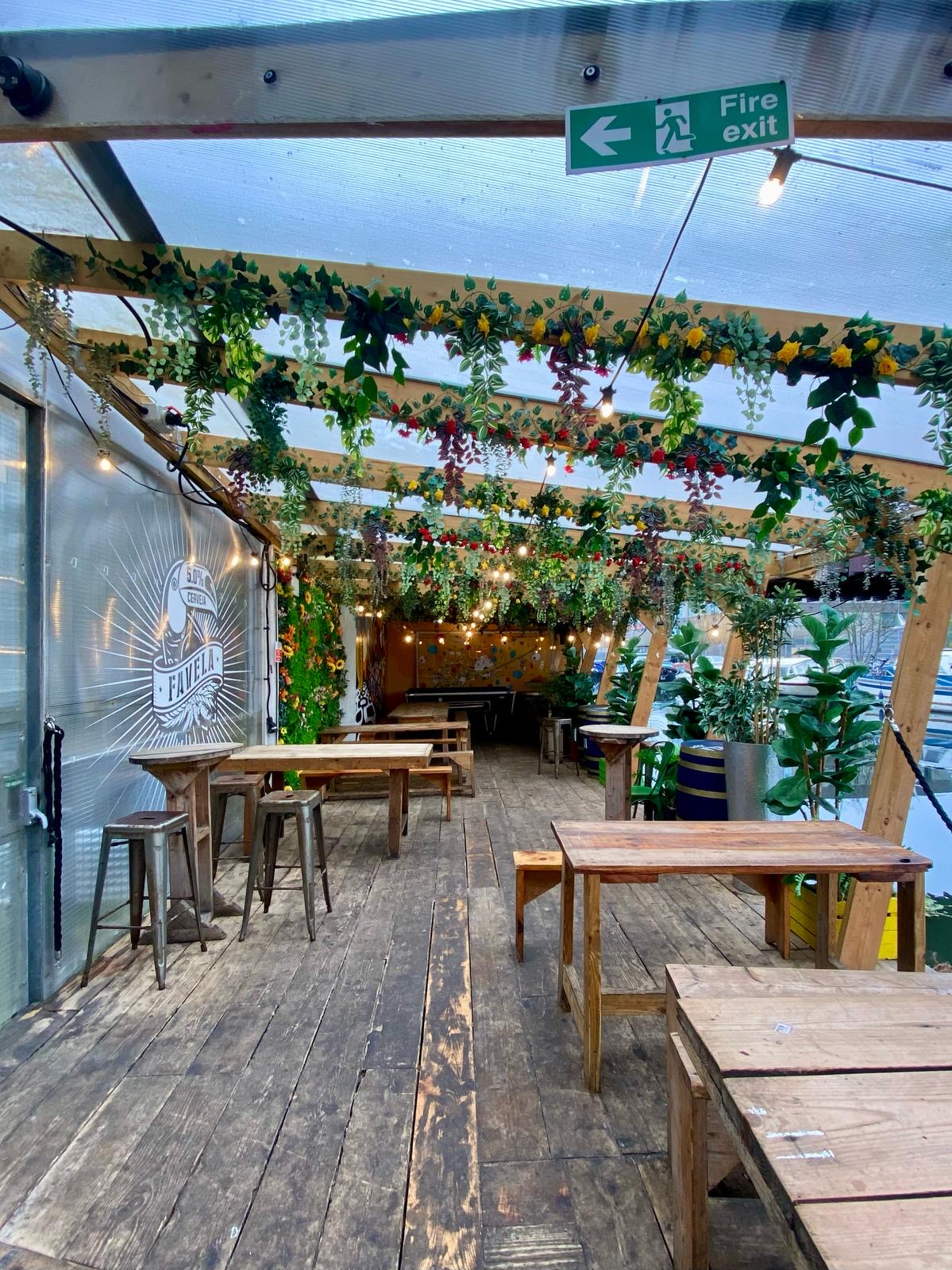 AstroDeck Terrace in Hackney Wick, decorated outdoor event space with lush greenery.