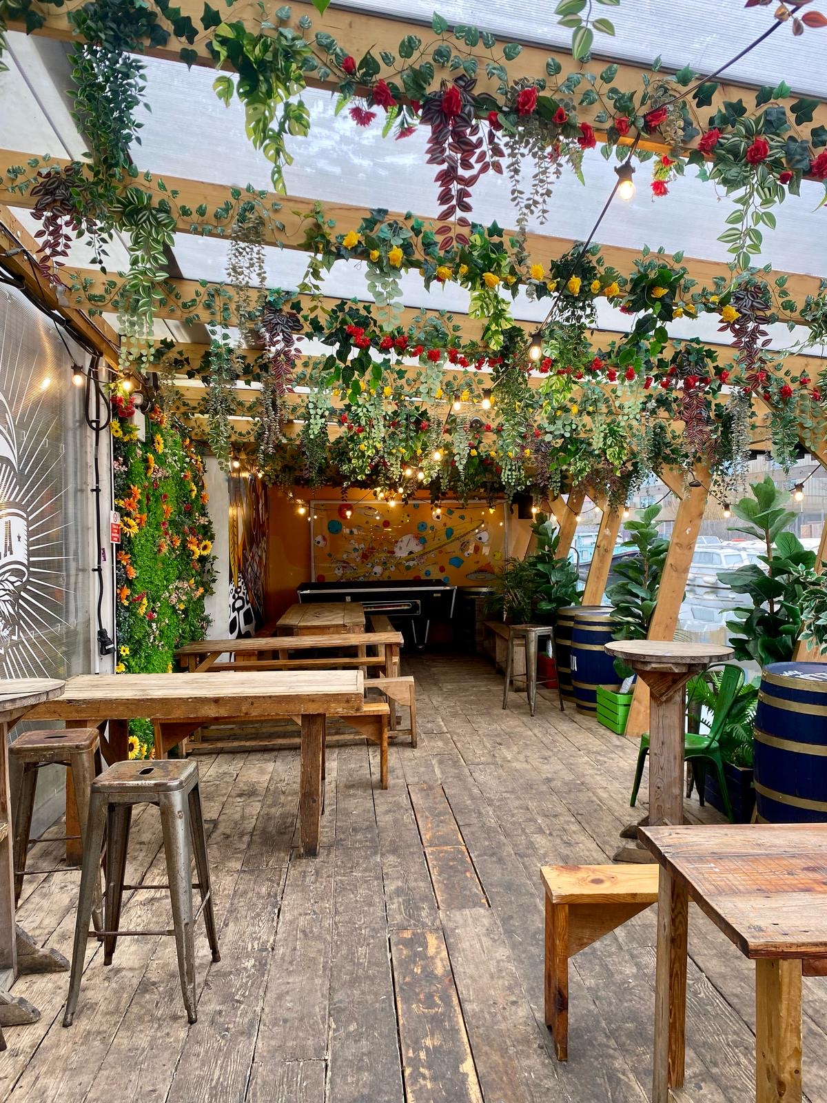 AstroDeck Terrace in Hackney Wick: rustic event space with greenery, ideal for gatherings.