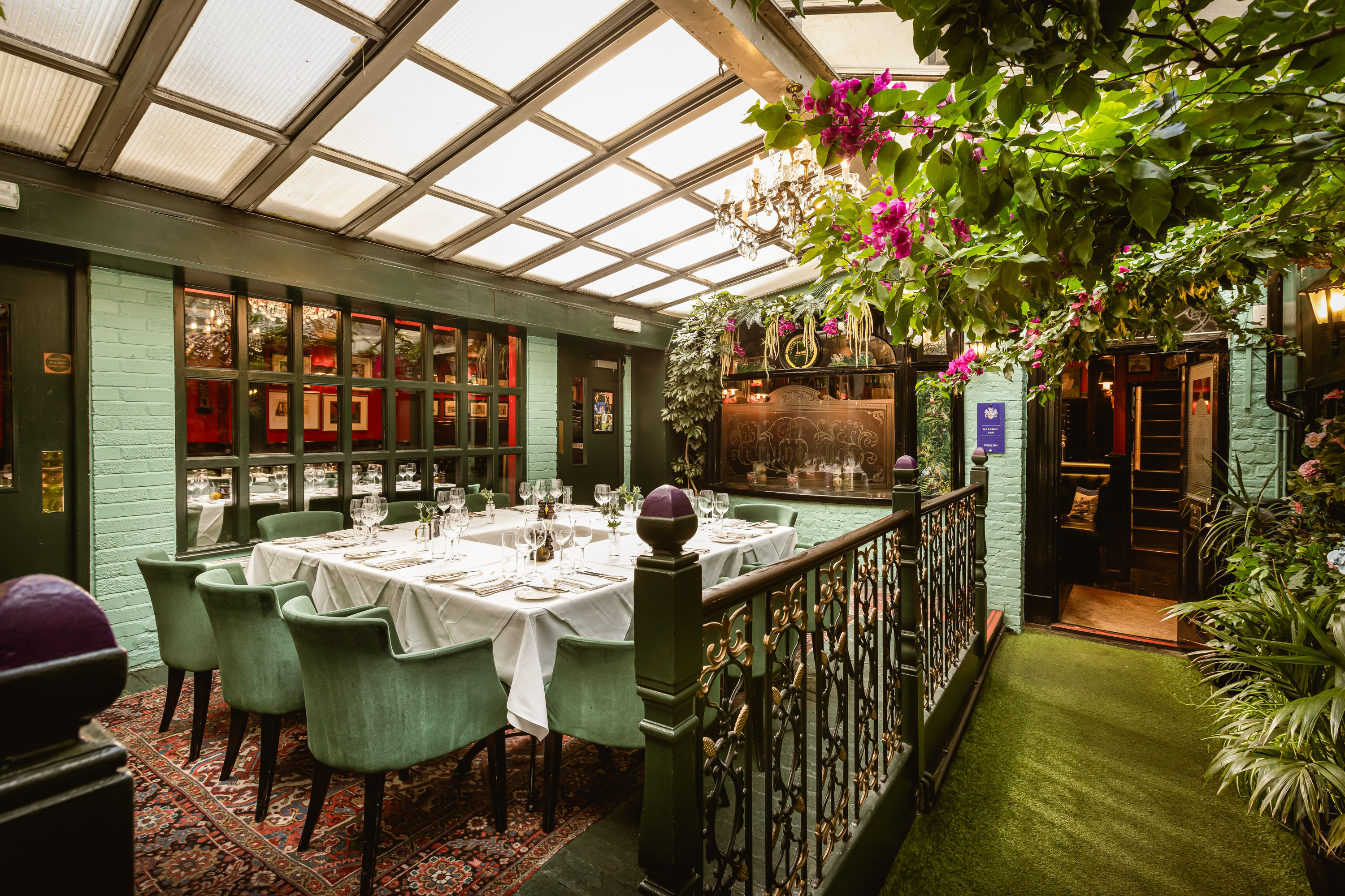 Elegant courtyard garden with glass ceiling, perfect for corporate dinners or private events.